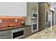 Kitchen featuring modern stainless steel appliances including Wolf oven and microwave at 14123 W Greentree S Dr, Litchfield Park, AZ 85340