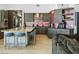 Modern kitchen featuring gray cabinets, a large island with seating, and stainless steel appliances at 14123 W Greentree S Dr, Litchfield Park, AZ 85340
