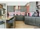 This designer kitchen boasts a large island with seating, wooden cabinets, and stainless steel appliances at 14123 W Greentree S Dr, Litchfield Park, AZ 85340