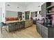 Bright, spacious kitchen with sleek cabinets, island with seating, and stainless steel appliances at 14123 W Greentree S Dr, Litchfield Park, AZ 85340