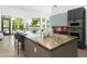 Modern kitchen with island, marble countertops, stainless steel appliances, and backyard view at 14123 W Greentree S Dr, Litchfield Park, AZ 85340