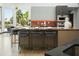 Modern kitchen showcases a breakfast bar, designer lighting, and an open layout to the dining area at 14123 W Greentree S Dr, Litchfield Park, AZ 85340