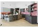Modern kitchen featuring a breakfast bar, sleek cabinetry, stainless steel appliances, and designer finishes at 14123 W Greentree S Dr, Litchfield Park, AZ 85340