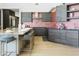 Contemporary kitchen with stainless steel appliances, a central island, and modern gray cabinets at 14123 W Greentree S Dr, Litchfield Park, AZ 85340