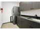 Well-equipped laundry room with washer, dryer, countertop, sink, and storage cabinets at 14123 W Greentree S Dr, Litchfield Park, AZ 85340