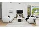 Inviting living room with stylish seating, modern decor, and a view to the outdoor living space at 14123 W Greentree S Dr, Litchfield Park, AZ 85340