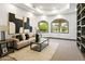 Cozy living room with neutral tones, modern art, and natural light from large windows at 14123 W Greentree S Dr, Litchfield Park, AZ 85340