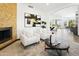 Bright living room with modern decor, a stone accent wall, and an open view to other living spaces at 14123 W Greentree S Dr, Litchfield Park, AZ 85340