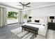 Bright main bedroom featuring a view of the golf course and a ceiling fan at 14123 W Greentree S Dr, Litchfield Park, AZ 85340
