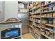 Well-organized pantry with ample shelving and a variety of food items at 14123 W Greentree S Dr, Litchfield Park, AZ 85340
