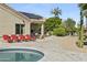 Inviting backyard featuring a pool, lounge chairs, and lush landscaping for outdoor enjoyment at 14123 W Greentree S Dr, Litchfield Park, AZ 85340