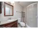 Well-maintained bathroom with wood vanity, a countertop sink, toilet and shower at 14300 W Bell Rd # 100, Surprise, AZ 85374