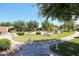 Beautifully landscaped community greenspace with walking paths, mature trees, and well-maintained lawns at 14300 W Bell Rd # 100, Surprise, AZ 85374