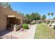 Condo exterior with covered patio and well-maintained landscaping at 14300 W Bell Rd # 100, Surprise, AZ 85374