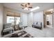 Bright living room with ceiling fan, neutral decor and large window at 14300 W Bell Rd # 100, Surprise, AZ 85374