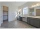 Large Primary bathroom boasts double sinks, walk-in closet and modern fixtures at 16355 W Desert Mirage Dr, Surprise, AZ 85388
