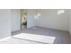 Spacious carpeted bedroom featuring natural light and a view into the en suite bathroom at 16355 W Desert Mirage Dr, Surprise, AZ 85388