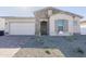 Charming single-story home featuring stone accents, a two-car garage, and desert landscaping at 16355 W Desert Mirage Dr, Surprise, AZ 85388