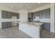 Modern kitchen featuring gray cabinets, white quartz countertops, and stainless steel appliances at 16355 W Desert Mirage Dr, Surprise, AZ 85388