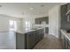 Modern kitchen featuring gray cabinets, white quartz countertops, and stainless steel appliances at 16355 W Desert Mirage Dr, Surprise, AZ 85388