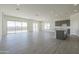 Spacious open-concept living room and kitchen with tile flooring, recessed lighting, and backyard views at 16355 W Desert Mirage Dr, Surprise, AZ 85388
