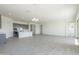 Spacious open-concept living room and kitchen with tile flooring, recessed lighting, and backyard views at 16355 W Desert Mirage Dr, Surprise, AZ 85388