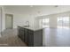 Open-concept living room with tile flooring, recessed lighting and large windows with backyard views at 16355 W Desert Mirage Dr, Surprise, AZ 85388