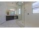 Bathroom showcasing tile floors, a glass shower, and a double vanity at 16367 W Desert Mirage Dr, Surprise, AZ 85388