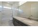 Bathroom with a white shower/tub combo, dark cabinets, and marble countertops at 16367 W Desert Mirage Dr, Surprise, AZ 85388