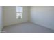 Cozy bedroom with carpet, baseboards, and a window at 16367 W Desert Mirage Dr, Surprise, AZ 85388