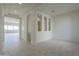 Spacious living room with neutral tile flooring and ample natural light at 16367 W Desert Mirage Dr, Surprise, AZ 85388