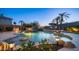 Lush backyard featuring a pool with water features, patio areas, and tranquil landscaping for relaxation at 16432 S Mountain Stone Trl, Phoenix, AZ 85048