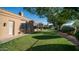 Well-maintained backyard with lush green lawn, mature trees, providing a serene outdoor space at 16432 S Mountain Stone Trl, Phoenix, AZ 85048