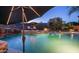 Relaxing backyard pool with stone accents, lounge seating, and lush greenery, perfect for outdoor enjoyment at 16432 S Mountain Stone Trl, Phoenix, AZ 85048