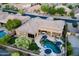 Expansive property featuring a private pool, covered patio, and lush landscaping viewed aerially at 16432 S Mountain Stone Trl, Phoenix, AZ 85048
