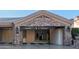 Spacious three-car garage with stone accents and ample storage space, including built in cabinets at 16432 S Mountain Stone Trl, Phoenix, AZ 85048