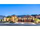 Charming home featuring a beautiful stone facade, three-car garage, and manicured landscaping, showcasing elegance at 16432 S Mountain Stone Trl, Phoenix, AZ 85048