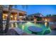 Beautiful backyard pool with patio seating, lush landscaping, and a calming ambiance, ideal for relaxing at 16432 S Mountain Stone Trl, Phoenix, AZ 85048