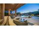 Relaxing outdoor patio area with comfortable seating, pool views, and landscape lighting at 16432 S Mountain Stone Trl, Phoenix, AZ 85048
