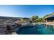 Refreshing pool with waterfall, lush landscaping, and lounge chairs, perfect for outdoor enjoyment at 16432 S Mountain Stone Trl, Phoenix, AZ 85048