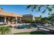 Lush backyard with a sparkling pool, stone accents, and inviting patio seating for outdoor relaxation and entertainment at 16432 S Mountain Stone Trl, Phoenix, AZ 85048