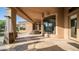Covered patio providing ample shade, outdoor seating, and easy access to both the backyard and interior spaces at 16432 S Mountain Stone Trl, Phoenix, AZ 85048