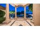 Grand entrance featuring stone pillars, decorative tile flooring, and a picturesque view of the neighborhood at 16432 S Mountain Stone Trl, Phoenix, AZ 85048