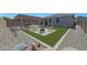 Backyard features a desert landscape, outdoor seating with pergola, and artificial turf at 18746 W Rancho Dr, Litchfield Park, AZ 85340
