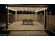 Outdoor patio with stylish pergola, string lights, and a dining set, creating a welcoming entertainment space at 18746 W Rancho Dr, Litchfield Park, AZ 85340