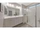 Bathroom boasts double sinks, granite countertop, with a seamless glass shower at 18746 W Rancho Dr, Litchfield Park, AZ 85340