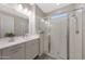 Modern bathroom with a spacious glass shower and a sleek, single-sink vanity at 18746 W Rancho Dr, Litchfield Park, AZ 85340