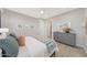 Serene bedroom with wood-look flooring, gray dresser, and easy access to the ensuite bathroom at 18746 W Rancho Dr, Litchfield Park, AZ 85340
