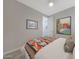 Comfortable bedroom featuring wood-look flooring, neutral paint, and a stylish decorative blanket at 18746 W Rancho Dr, Litchfield Park, AZ 85340
