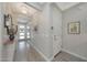 Inviting entryway with wood-look tile flooring, decorative lighting, and direct view of the front door at 18746 W Rancho Dr, Litchfield Park, AZ 85340